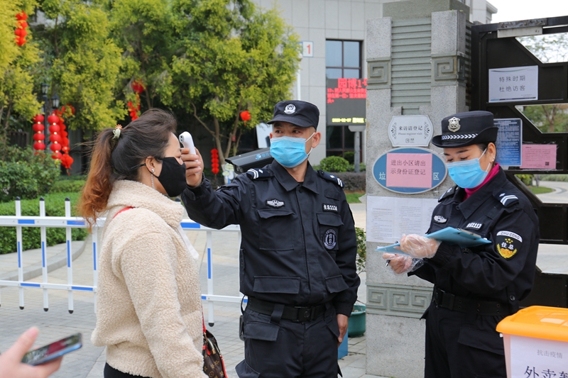 小区工作人员在对进出小区的人员检测体温（沈伟泉摄影）.JPG